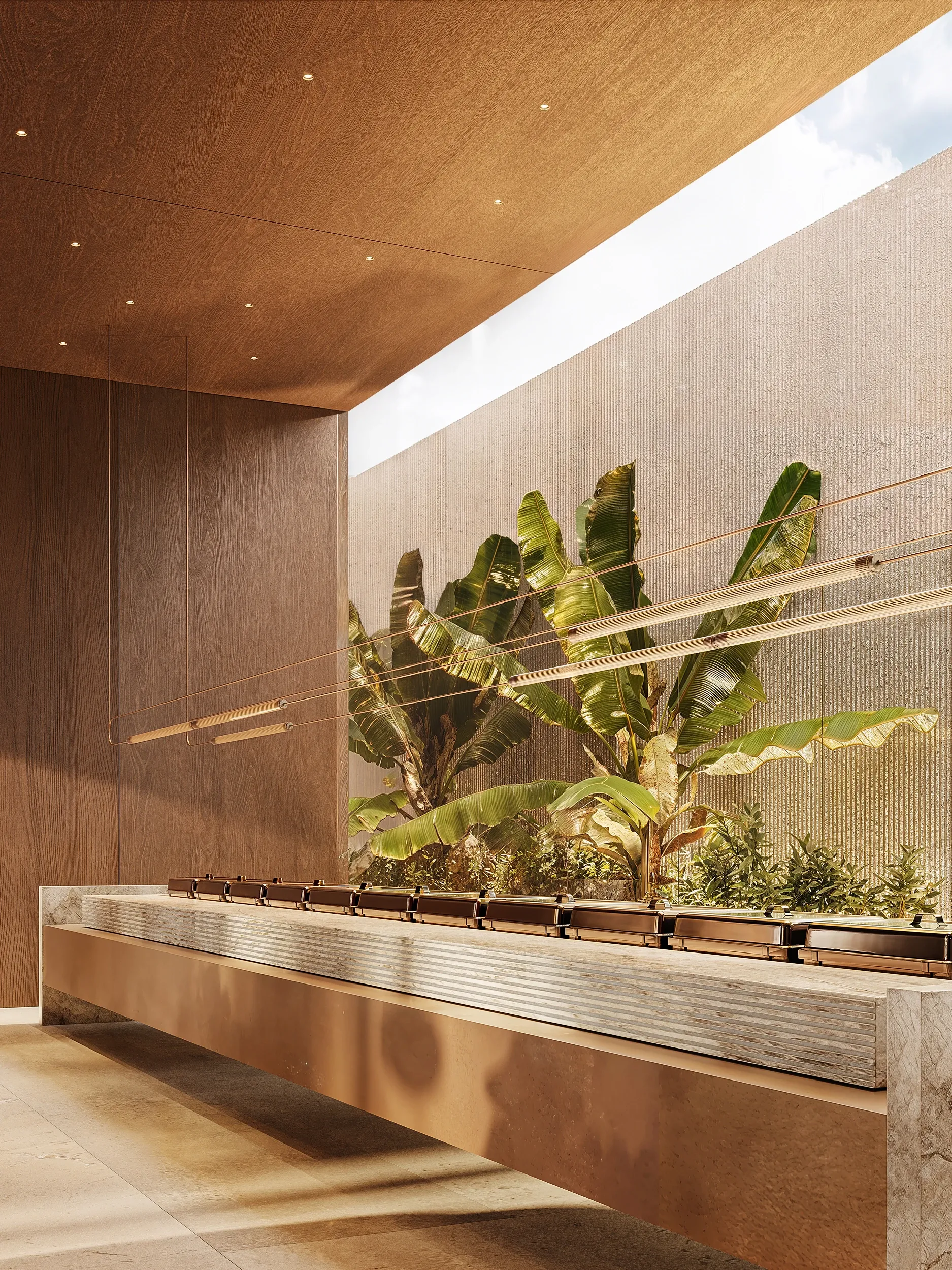 Bronze stone bench with banana leaf planting under skylight, Masaya Restaurant, The Ritz-Carlton Bahrain