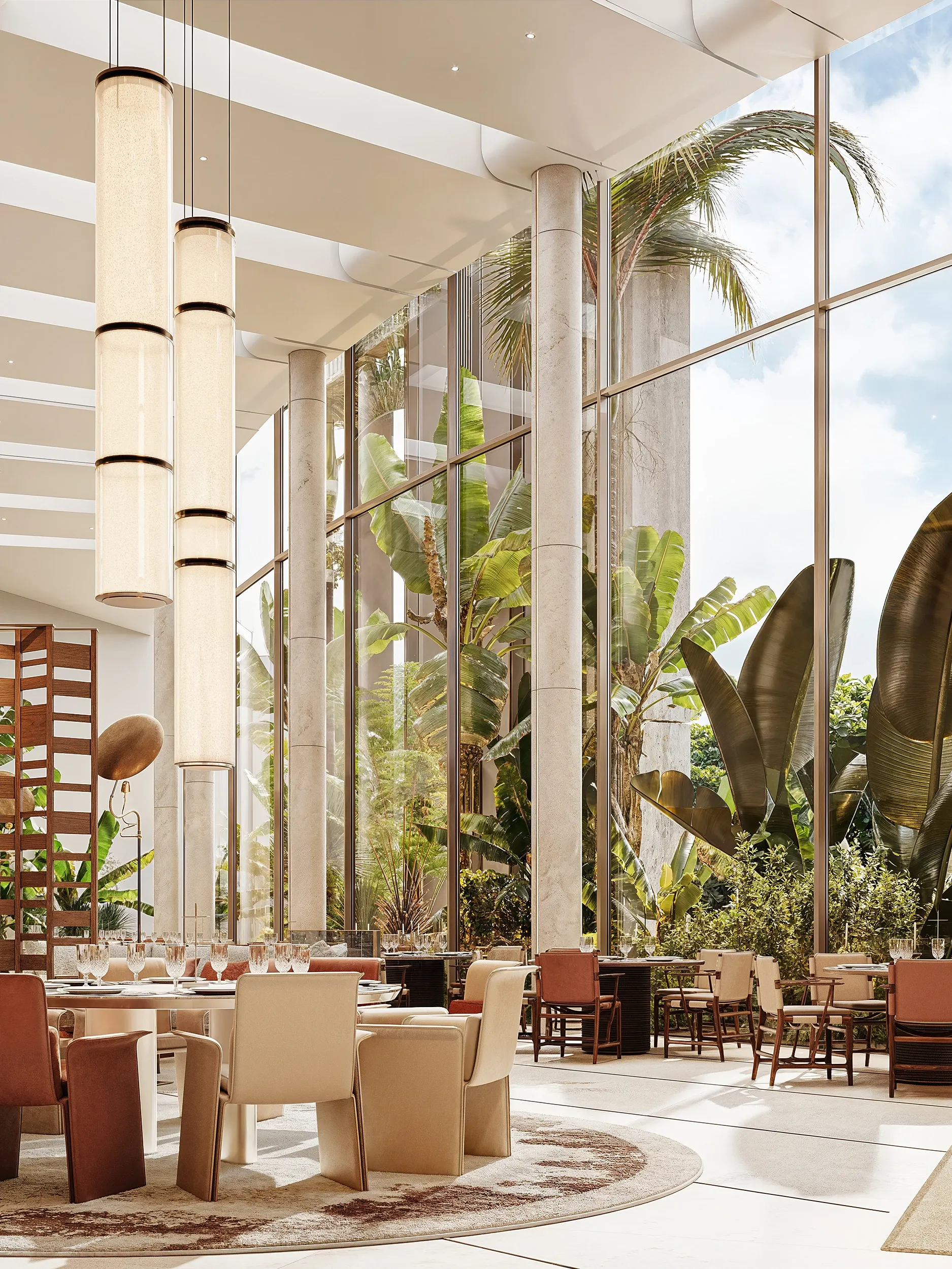 Dining table beneath pendant lamps facing glass wall and palm garden, Masaya Restaurant, The Ritz-Carlton Bahrain