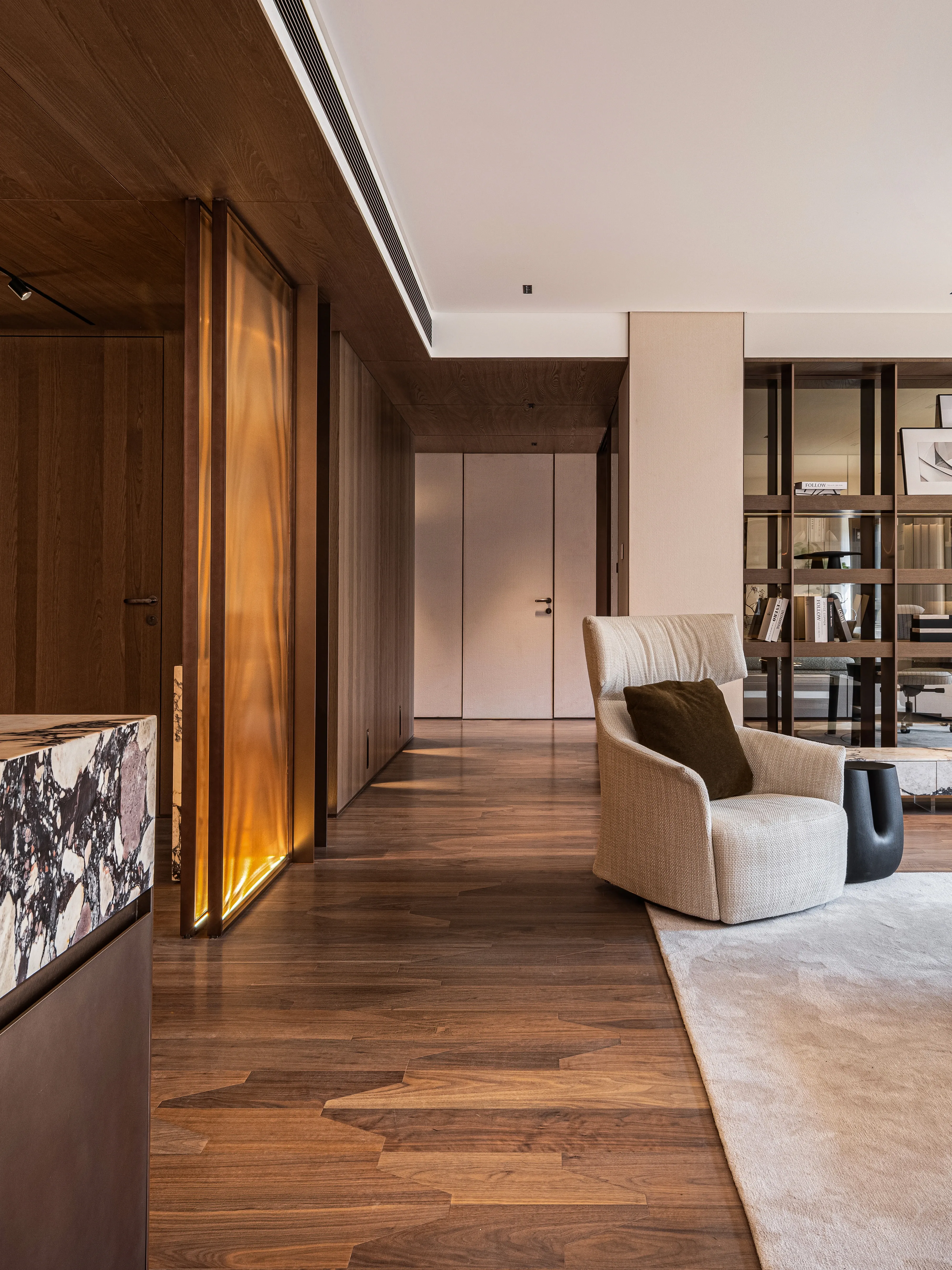 Hallway with backlit amber glass, herringbone oak floor, The Amber Residence, Beijing