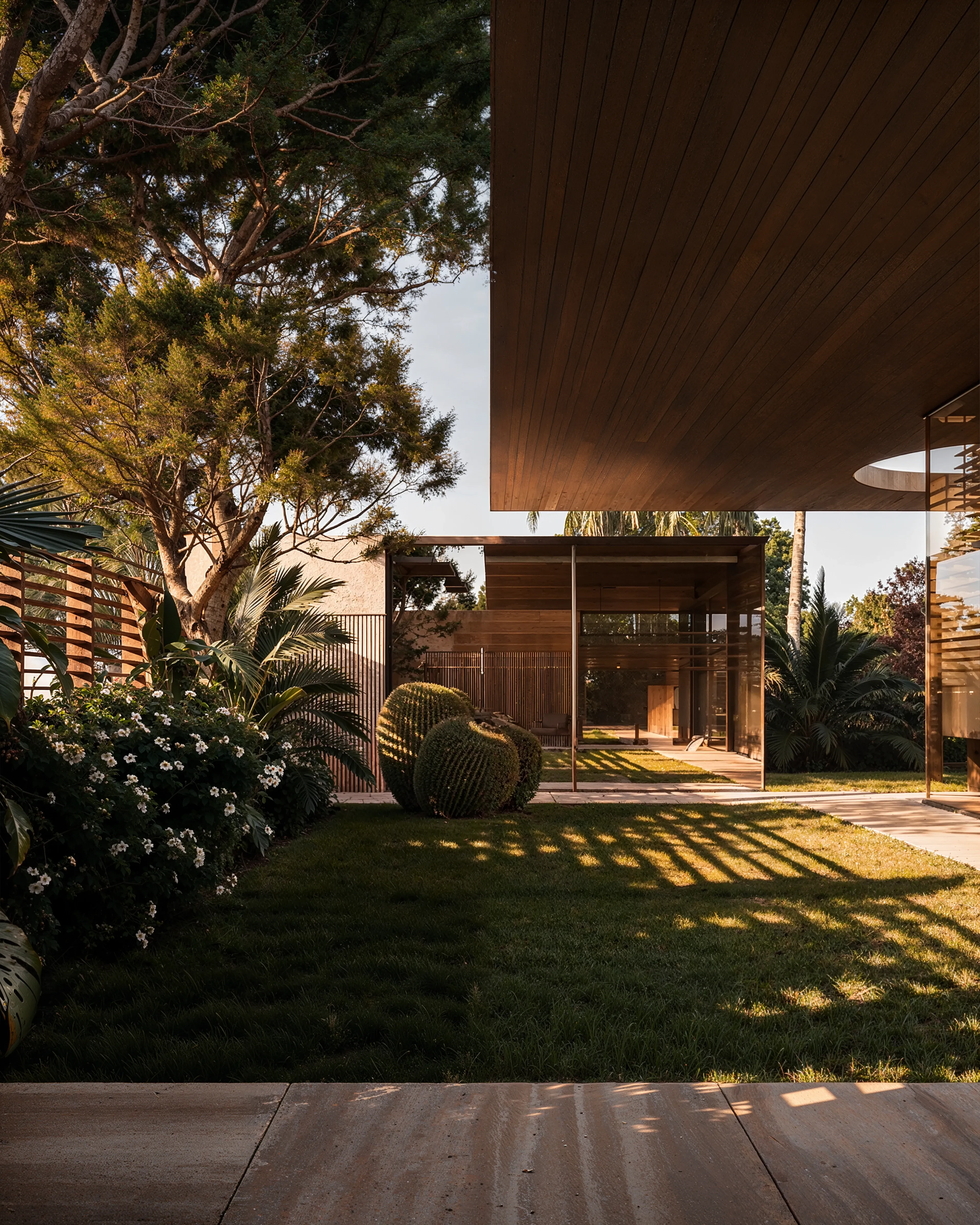 Courtyard garden with timber ceiling overhang and glass pavilion beyond, The Desert Pavilion, Riyadh